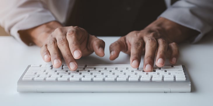 Blog Featured Image_Business man typing on keyboard