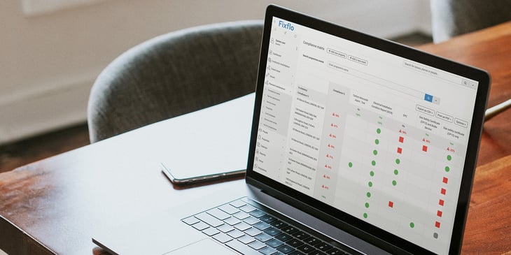A laptop with Fixflo's Planned Preventative Matrix solution on a wooden office desk