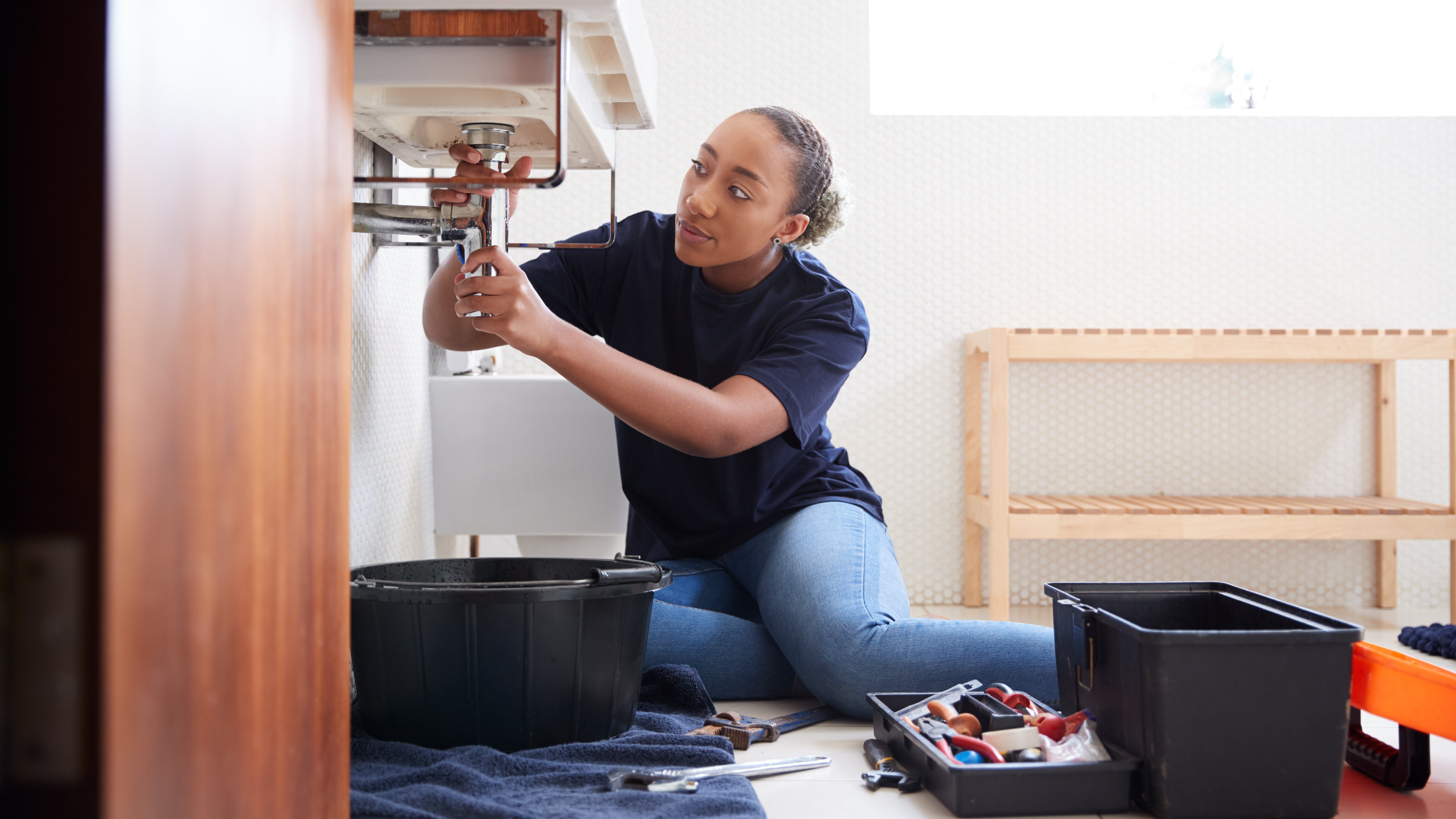 female-plumber-working-to-fix-leaking-sink-in-home-2021-08-27-08-40-15-utc