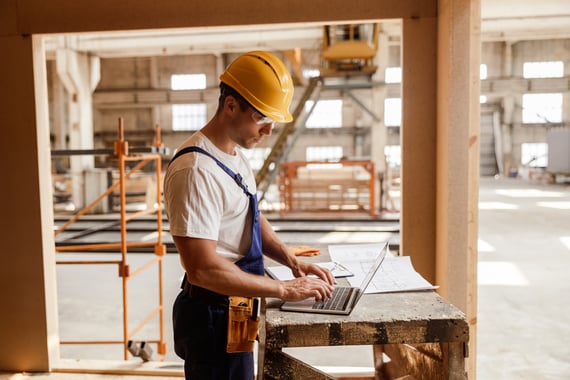 male-builder-using-modern-laptop-at-work-2022-01-26-23-38-27-utc